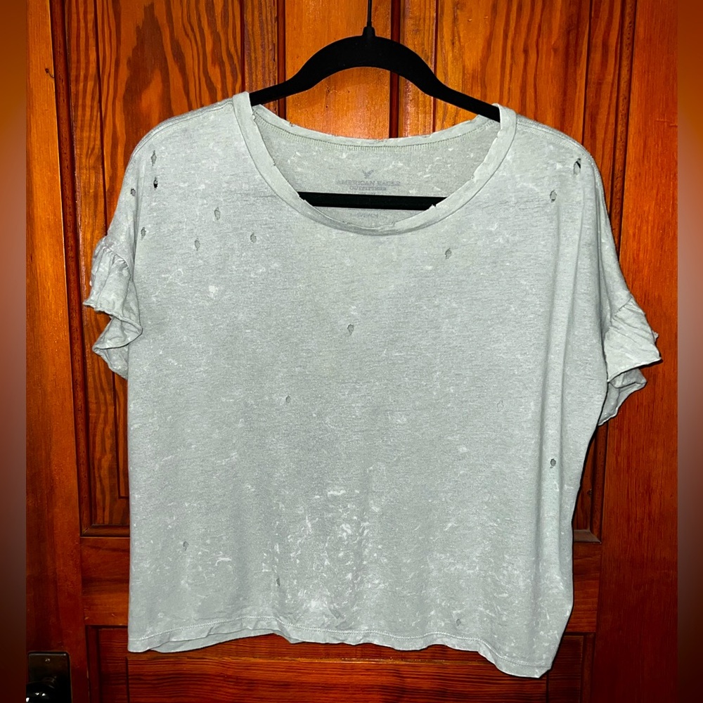 American eagle top light green with ruffle sleeves!! Distress holes!! Size small